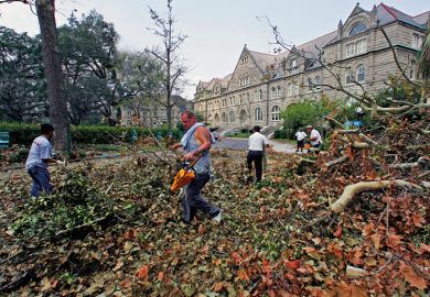 Workers remove debris at Tulane University after Hurricane Katrina