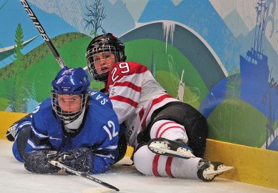 two female ice hockey players lying on the ice