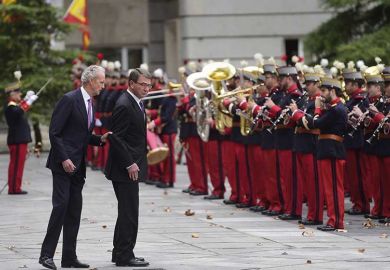 Spanish Defence Minister Pedro Morenes (L) speaks with US Secretary of Defense Ashton Carter as they review the troops in Madrid on October 5, 2015