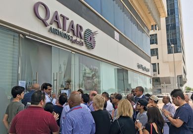 People gather outside a branch of Qatar Airways in the United Arab Emirate of Abu Dhabi on June 6 after ban on Qatari flights