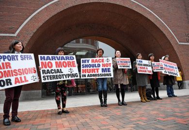 Demonstrators hold slogans in front of John Joseph Moakley United States Courthouse in Boston, Massachusetts