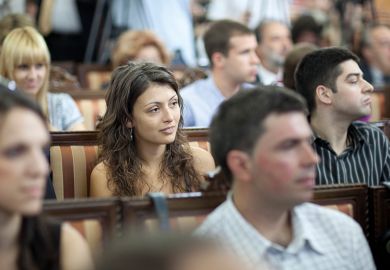 A student sitting in a lecture theatre