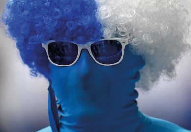 Person wearing morph suit and curly wig in Finland flag colours