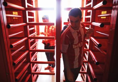Supporters enter the ground through the turnstiles prior to the Barclays Premier League match between Stoke City and Norwich City at the Britannia Stadium in Stoke on Trent, England