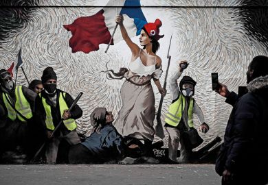 A man takes a picture of a mural by street artist PBOY depicting Yellow Vest (gilets jaunes) protestors inspired by "La Liberte guidant le Peuple" painting by Eugene Delacroix in Paris on January 8, 2019 A man takes a picture of a mural by street artist PBOY depicting Yellow Vest (gilets jaunes) protestors inspired by "La Liberte guidant le Peuple" painting by Eugene Delacroix in Paris on January 8, 2019