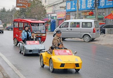 A farmer and his wife drive his miniature home-made Lamborghini. China