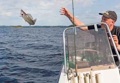 Man throwing fish back