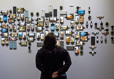 A person looking at various smart phones