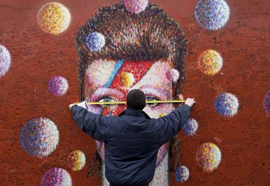 A workman measures up a mural of British musician David Bowie in Brixton, south London A workman measures up a mural of British musician David Bowie in Brixton, south London