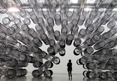 A woman looks at an art installation of bicycles in Taipei October 28, 2011