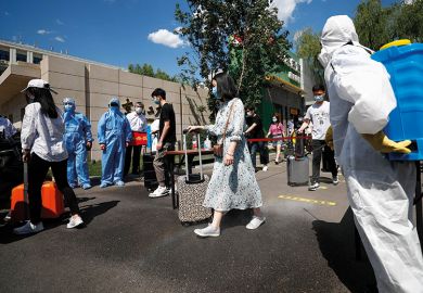 Teachers wearing face masks take part in a drill at Beijing University of Chemical Technology on May 27, 2020 in Beijing, China. The university carried out an epidemic prevention and control drill on Wednesday in preparation for its reopening. 