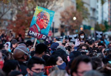 People celebrate at Black Lives Matter Plaza across from the White House in Washington, DC on November 7, 2020, after Joe Biden was declared the winner of the 2020 presidential election