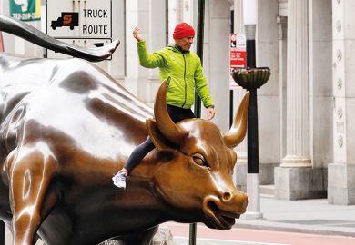 A person can be seen riding the Charging Bull in the financial distrcict of New York City amid Coronavirus pandemic on April 5, 2020. A person can be seen riding the Charging Bull in the financial distrcict of New York City amid Coronavirus pandemic on April 5, 2020.