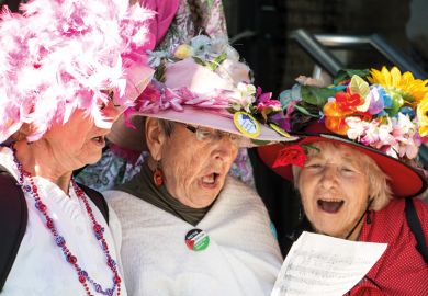 Three women singing from same hymn sheet Three women singing from same hymn sheet