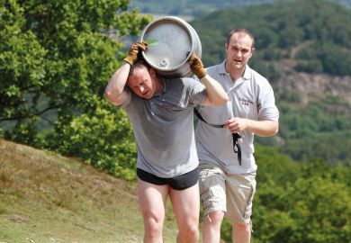 Tired man carrying beer barrel uphill Tired man carrying beer barrel uphill