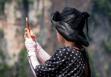Tourist taking selfies in Zhangjiajie Tianzi lookout Tourist taking selfies in Zhangjiajie Tianzi lookout