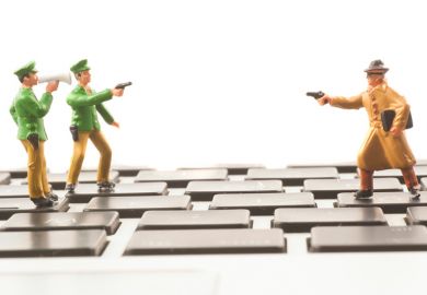 Toy cops and robber on keyboard