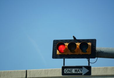 A red traffic light and a "one way" sign, symbolising research direction