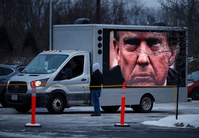 A digital billboard truck with a giant image of Donald Trump tries to park outside a campaign rally