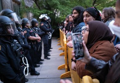 University police are confronted by protestors on the University of Chicago campus while they break up a pro-Palestinian encampment to illustrate The problem of US campus policing
