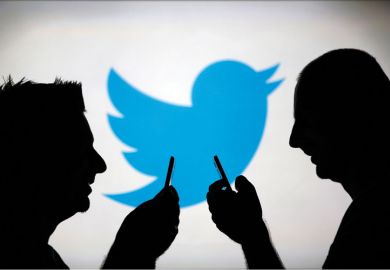 Men using smartphones against Twitter backdrop
