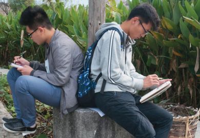 Two male art students sketching back-to-back, Hongcun village, Anhui, China