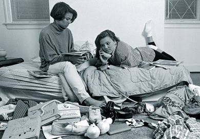 Two teenage girls in a messy bedroom
