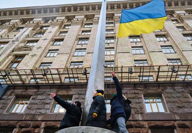 Activists hold Ukrainian flag during an action near the Kyiv City Council, demanding more money from the city budget for the Ukrainian armed forces Activists hold Ukrainian flag during an action near the Kyiv City Council, demanding more money from the city budget for the Ukrainian armed forces
