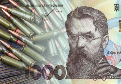 Ukrainian hryvnia against the background of machine gun cartridges