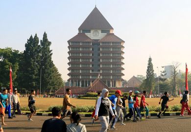 People jogging in front of rectorate building of Universitas Indonesia, Depok, Indonesia. People jogging in front of rectorate building of Universitas Indonesia, Depok, Indonesia.