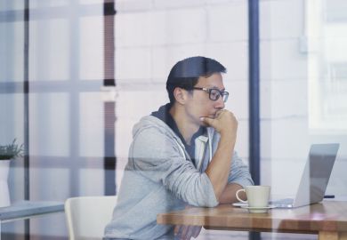 Asian man using laptop