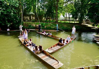 Visitor punting on river Cherwell in Oxford