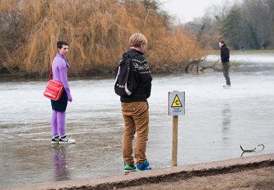 Frozen lake with sign for Danger Thin Ice with people standing on it, as an illustration of the ‘wafer-thin margins’ faced by middle-tier universities as financial challenges arise from government proposal for a overseas student levy. Frozen lake with sign for Danger Thin Ice with people standing on it, as an illustration of the ‘wafer-thin margins’ faced by middle-tier universities as financial challenges arise from government proposal for a overseas student levy.