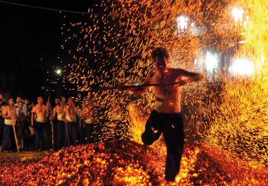 A man walking over burning coals A man walking over burning coals