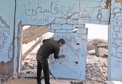 Palestinian artist draws Palestinian flag and Al-Aqsa Mosque, symbolising solidarity in Gaza, on the wall of a building that was heavily damaged as a result of the attacks in Rafah, Gaza on 30 April, 2024