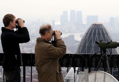 Birdwatchers use binoculars to observe birds from the top of Tower 42, London Birdwatchers use binoculars to observe birds from the top of Tower 42, London, illustrating UK institutions seeking to hire EU professors and postdocs
