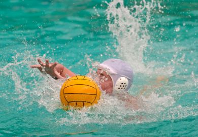 Water polo player swimming for the ball