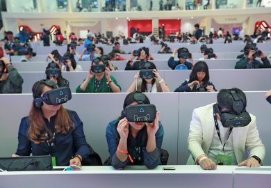 Members of the media wear virtual reality headsets in Shenzhen, Guangdong Province of China to illustrate AI-generated lecturers take a turn at Hong Kong university