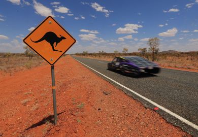 The Sunswift car 'Violet' from Australia passes a kangaroo sign to illustrate Oceania sets pace in sustainability race