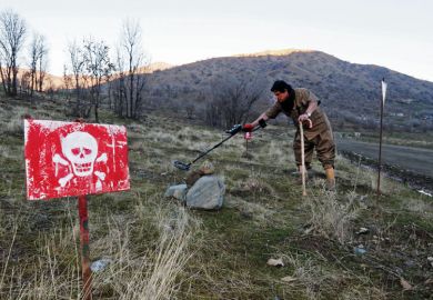 Person walks in a minefield trying to deactivate the devices on the outskirts of the Kurdish town of Halabja, Iraq Person walks in a minefield trying to deactivate the devices on the outskirts of the Kurdish town of Halabja, Iraq as a metaphor for ‘Tech without humanities leads to problems’