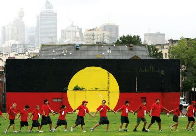 Students from Our Lady of Mount Carmel join hands to celebrate after watching the live television broadcast from the Australian Parliament in Canberra as a metaphor for Indigenous reconciliation ‘can get in way of act ion’ for universities