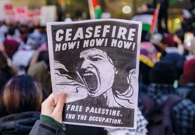 A pro-Palestinian protester carries a sign in Midtown Manhattan during a protest calling for a ceasefire between Israel and Hamas to illustrate US campuses try tolerance training to defuse Palestine protests