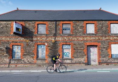 A cyclist rides past a boarded up retail unit A cyclist rides past a boarded up retail unit to illustrate UK’s university investment zones echo US, but leave questions