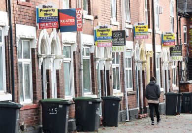 A man walks past a street of terraced houses advertising properties A man walks past a street of terraced houses advertising properties to illustrate Average student rents now eat up all of maintenance loan – survey