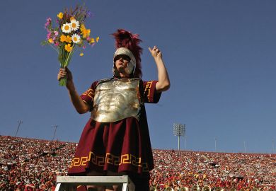 A USC Trojans mascot and the band cheer during the game with the Washington State Cougars to illustrate Waning powers