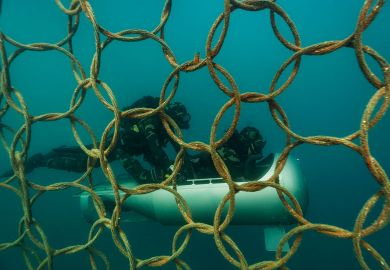 Two divers infant of steel protection under the sea with a submarine Two divers infant of steel protection under the sea with a submarine as a metaphor of Non-EU scientists face exclusion from sensitive Horizon projects