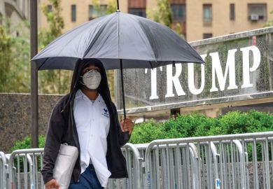 A person wears a protective face mask outside Trump International Hotel & Tower New York A person wears a protective face mask outside Trump International Hotel & Tower New York