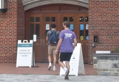 Students wearing face masks enter a makeshift COVID-19 testing area at Georgetown University Students wearing face masks enter a makeshift COVID-19 testing area at Georgetown University