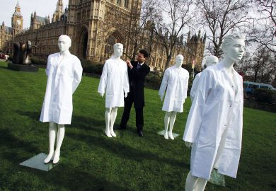 Group of unused laboratory coats and mannequins at Westminster, Central London to highlight the fact that the Government is cutting funding from the national research budget to illustrate Anger as social sciences lose cash to STEM under REF rule change