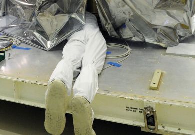 Person underneath a plastic sheet to illustrate Florida university leaders silent as DeSantis rages